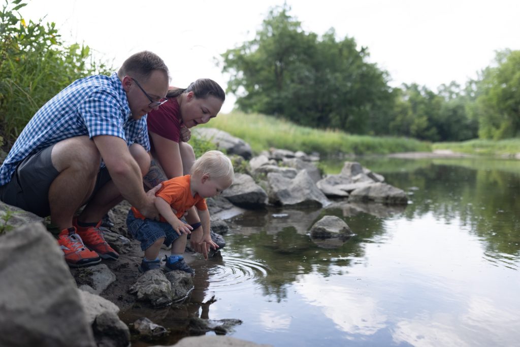 Family enjoying banks of Iowa river